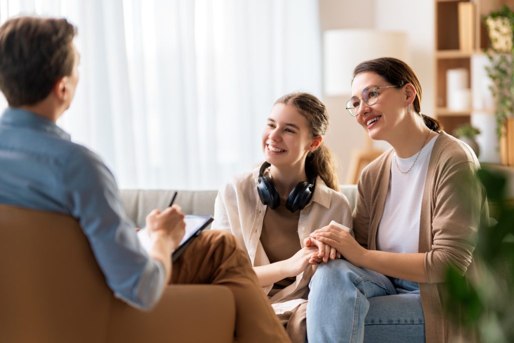 Family seated together smiling talking