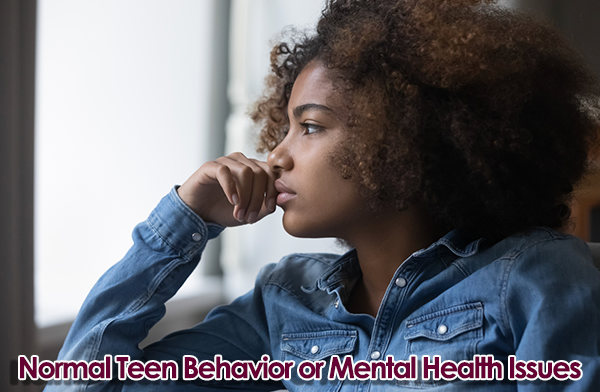 Young girl with depression looking out the window.