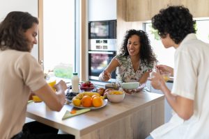 Feb Blog Caption Photo Breakfast of a Latino mother's family with their sons.