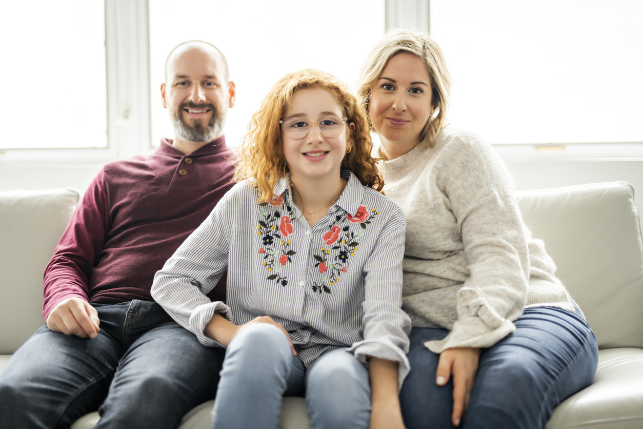 Family sitting next to each other smiling
